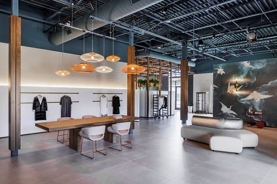 Wide view of the open floor with pendant lights, lounge, and mural wall
